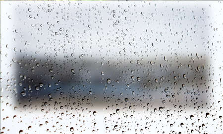 Background with rain drops close up. Rain drops on outdoor window, Closeup view transparent water drops on glass surface, humid water backdrop, blurred background with copy space for your textの写真素材