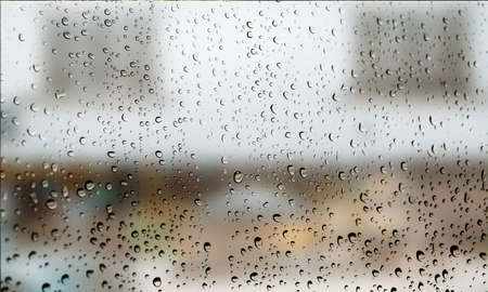 Background with rain drops close up. Rain drops on outdoor window, Closeup view transparent water drops on glass surface, humid water backdrop, blurred background with copy space for your textの写真素材