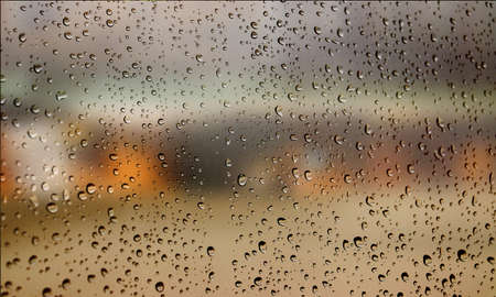 Background with rain drops close up. Rain drops on outdoor window, Closeup view transparent water drops on glass surface, humid water backdrop, blurred background with copy space for your textの写真素材