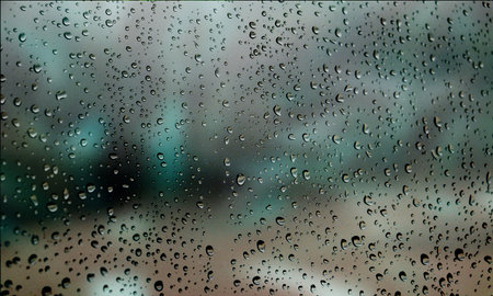 Background with rain drops close up. Rain drops on outdoor window, Closeup view transparent water drops on glass surface, humid water backdrop, blurred background with copy space for your textの写真素材