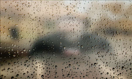 Background with rain drops close up. Rain drops on outdoor window, Closeup view transparent water drops on glass surface, humid water backdrop, blurred background with copy space for your textの写真素材