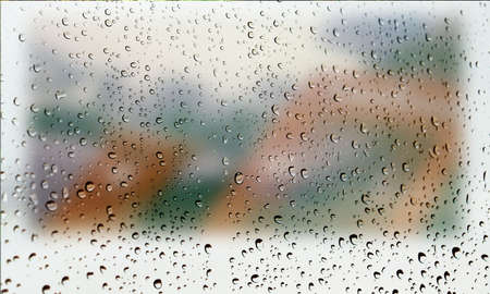 Background with rain drops close up. Rain drops on outdoor window, Closeup view transparent water drops on glass surface, humid water backdrop, blurred background with copy space for your textの写真素材