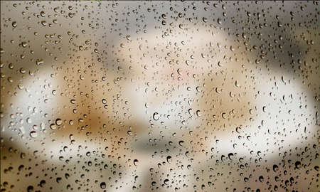 Background with rain drops close up. Rain drops on outdoor window, Closeup view transparent water drops on glass surface, humid water backdrop, blurred background with copy space for your textの写真素材