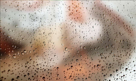 Background with rain drops close up. Rain drops on outdoor window, Closeup view transparent water drops on glass surface, humid water backdrop, blurred background with copy space for your textの写真素材