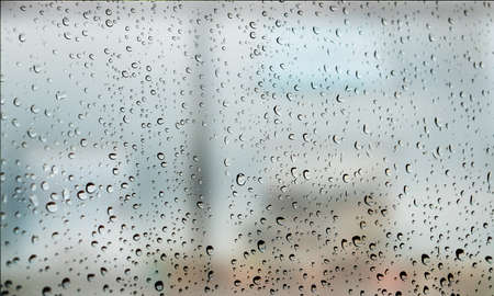 Background with rain drops close up. Rain drops on outdoor window, Closeup view transparent water drops on glass surface, humid water backdrop, blurred background with copy space for your textの写真素材