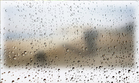 Background with rain drops close up. Rain drops on outdoor window, Closeup view transparent water drops on glass surface, humid water backdrop, blurred background with copy space for your textの写真素材