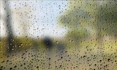 Background with rain drops close up. Rain drops on outdoor window, Closeup view transparent water drops on glass surface, humid water backdrop, blurred background with copy space for your textの写真素材