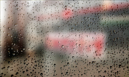Background with rain drops close up. Rain drops on outdoor window, Closeup view transparent water drops on glass surface, humid water backdrop, blurred background with copy space for your textの写真素材