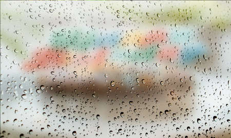Background with rain drops close up. Rain drops on outdoor window, Closeup view transparent water drops on glass surface, humid water backdrop, blurred background with copy space for your textの写真素材