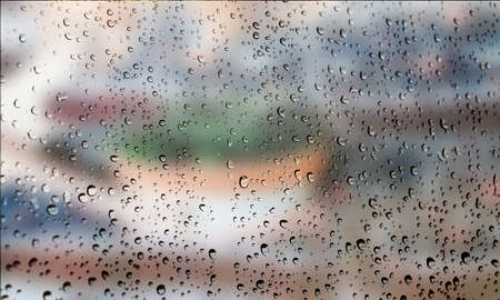 Background with rain drops close up. Rain drops on outdoor window, Closeup view transparent water drops on glass surface, humid water backdrop, blurred background with copy space for your textの写真素材