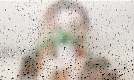 Background with rain drops close up. Rain drops on outdoor window, Closeup view transparent water drops on glass surface, humid water backdrop, blurred background with copy space for your textの写真素材