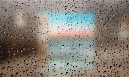 Background with rain drops close up. Rain drops on outdoor window, Closeup view transparent water drops on glass surface, humid water backdrop, blurred background with copy space for your textの写真素材