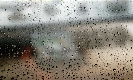 Background with rain drops close up. Rain drops on outdoor window, Closeup view transparent water drops on glass surface, humid water backdrop, blurred background with copy space for your textの写真素材