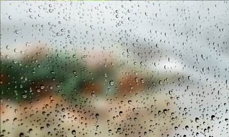 Background with rain drops close up. Rain drops on outdoor window, Closeup view transparent water drops on glass surface, humid water backdrop, blurred background with copy space for your textの写真素材