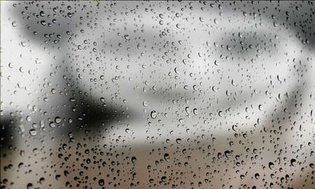 Background with rain drops close up. Rain drops on outdoor window, Closeup view transparent water drops on glass surface, humid water backdrop, blurred background with copy space for your textの写真素材