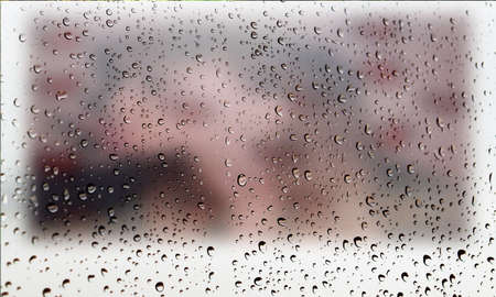Background with rain drops close up. Rain drops on outdoor window, Closeup view transparent water drops on glass surface, humid water backdrop, blurred background with copy space for your textの写真素材