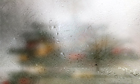 Background with rain drops close up. Rain drops on outdoor window, Closeup view transparent water drops on glass surface, humid water backdrop, blurred background with copy space for your textの写真素材