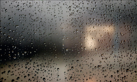 Background with rain drops close up. Rain drops on outdoor window, Closeup view transparent water drops on glass surface, humid water backdrop, blurred background with copy space for your textの写真素材