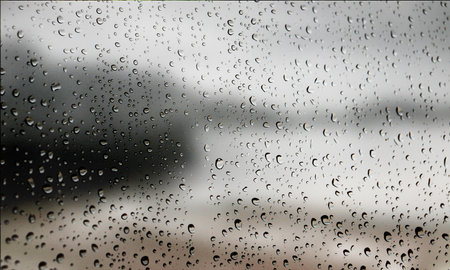 Background with rain drops close up. Rain drops on outdoor window, Closeup view transparent water drops on glass surface, humid water backdrop, blurred background with copy space for your textの写真素材