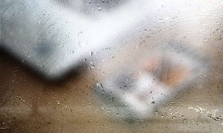 Background with rain drops close up. Rain drops on outdoor window, Closeup view transparent water drops on glass surface, humid water backdrop, blurred background with copy space for your textの写真素材