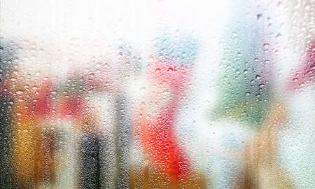 Background with rain drops close up. Rain drops on outdoor window, Closeup view transparent water drops on glass surface, humid water backdrop, blurred background with copy space for your textの写真素材