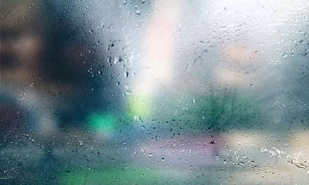 Background with rain drops close up. Rain drops on outdoor window, Closeup view transparent water drops on glass surface, humid water backdrop, blurred background with copy space for your textの写真素材