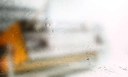 Background with rain drops close up. Rain drops on outdoor window, Closeup view transparent water drops on glass surface, humid water backdrop, blurred background with copy space for your textの写真素材