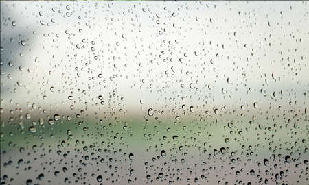 Water drops on glass with blurred background. Rain drops on window.