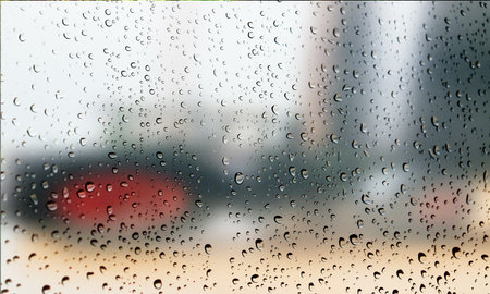 Water drops on glass with blurred background. Rain drops on window.