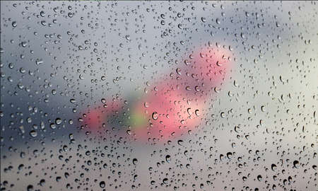 Background with rain drops close up. Rain drops on outdoor window, Closeup view transparent water drops on glass surface, humid water backdrop, blurred background with copy space for your textの写真素材