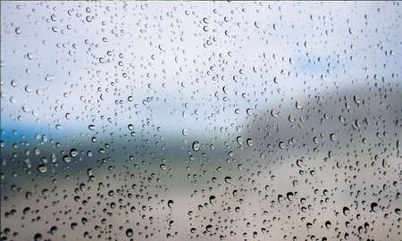 Background with rain drops close up. Rain drops on outdoor window, Closeup view transparent water...