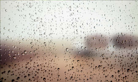 Background with rain drops close up. Rain drops on outdoor window, Closeup view transparent water...