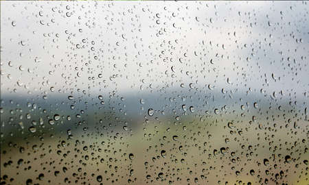 Water drops on the glass, natural background. Rain drops on the window.