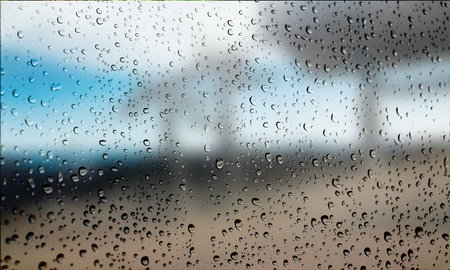 Background with rain drops close up. Rain drops on outdoor window, Closeup view transparent water drops on glass surface, humid water backdrop, blurred background with copy space for your textの写真素材