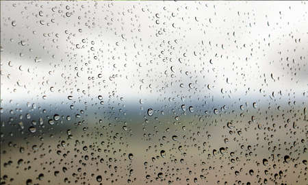 Water drops on the glass with blurred background. Rain drops on the window.
