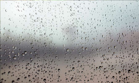 Background with rain drops close up. Rain drops on outdoor window, Closeup view transparent water...