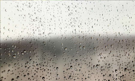 Background with rain drops close up. Rain drops on outdoor window, Closeup view transparent water...