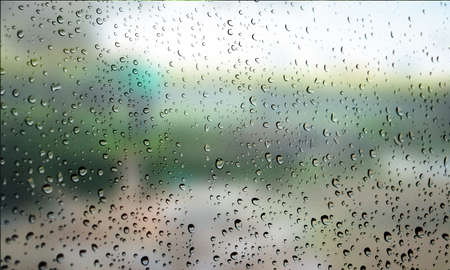 Drops of rain on the window, rainy day. Shallow DOF