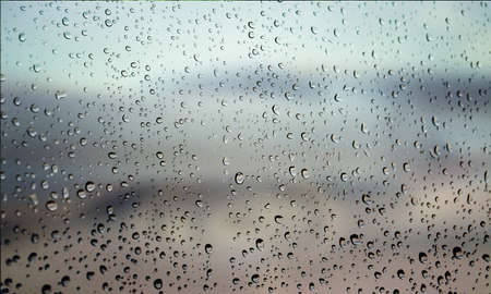 Background with rain drops close up. Rain drops on outdoor window, Closeup view transparent water...