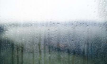 Rain drops on the glass. Raindrops on the window in rainy weather.