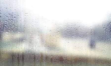 Water drops on glass with blurred background. Rain drops on window. Natural background.
