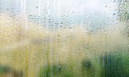 Background with rain drops close up. Rain drops on outdoor window, Closeup view transparent water...