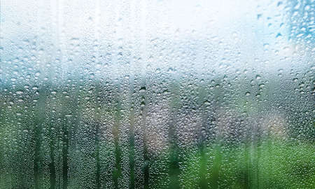 Water drops on the glass. Rain drops on the window, blurred background.