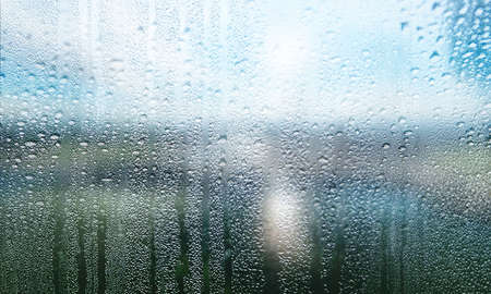 Rain drops on the window, closeup view. Rainy weather background