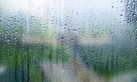 Condensation on the window. Rain drops on the glass. Natural background.