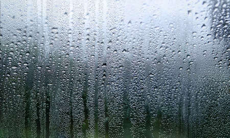 Water drops on window glass. Raindrops on window glass background.
