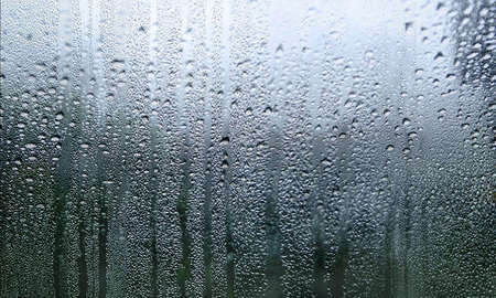 Condensation on the window. Water drops on the glass. Rainy weather.