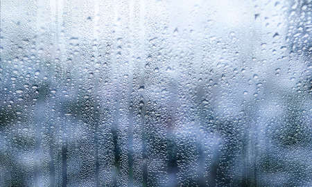 Water drops on a window glass. Drops of rain on the window. Rain drops on a window.