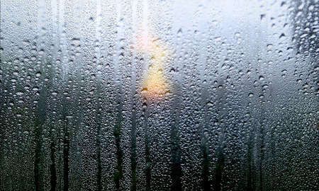 Condensation on the window. Rain drops on the glass. Natural background.