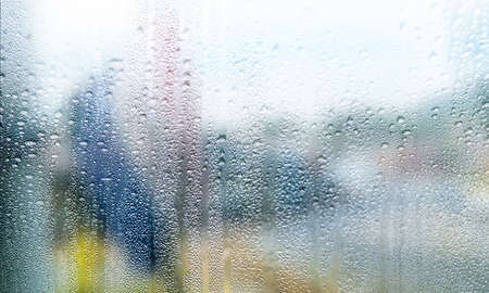 Condensation on the window, rain drops on the glass, blurred background